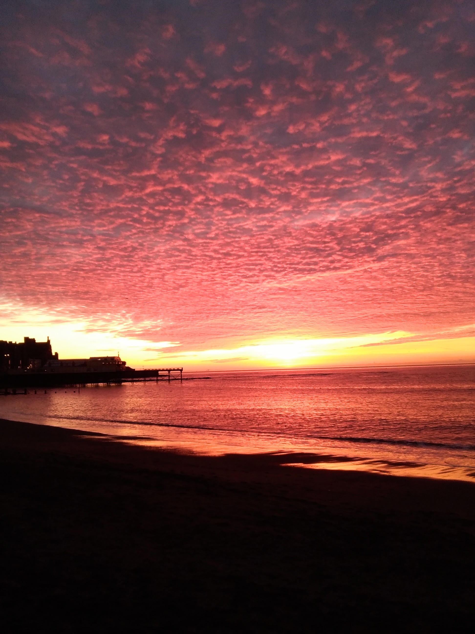 Aberystwyth sunset, showing the silhouette of Aberystwyth Pier. © Lara Kipp