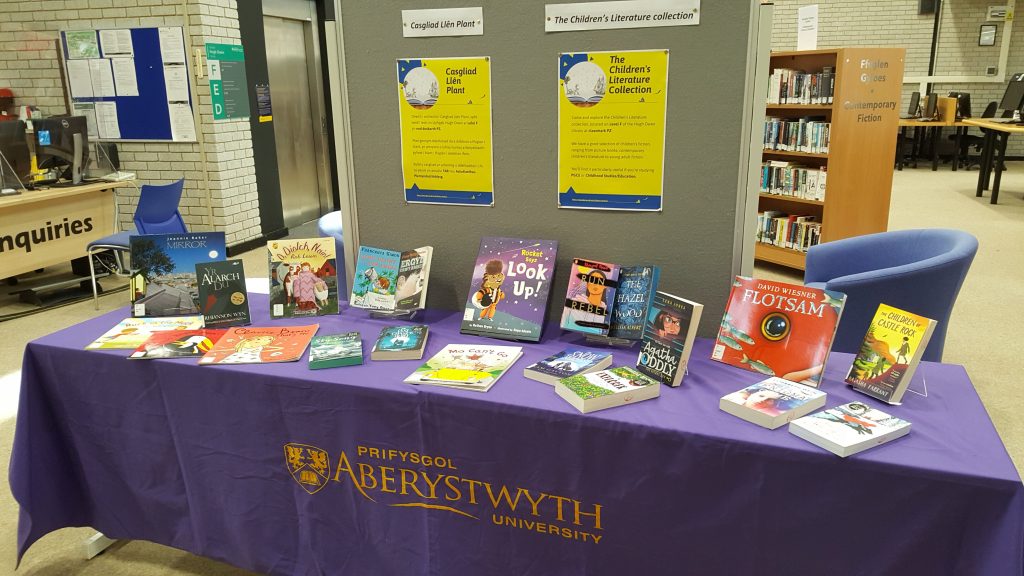 Colourful books from the Children's Literature Collection on a table on Level F of the Hugh Owen Library