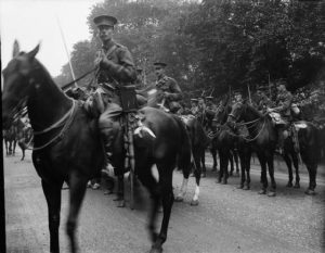 The image shows a mounted cavalry unit led by Captain Gerrad Leigh