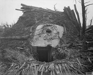 The image shows the exterior of a German dug out in 1916, with a large pile of earth and concrete on top of it