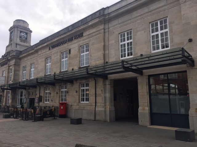 Front view of The Workstation featuring a large building with a clock tower